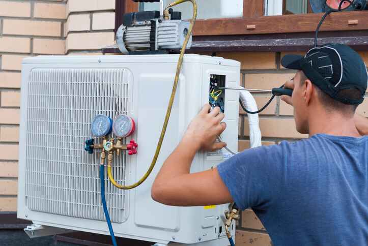 technician servicing an HVAC system