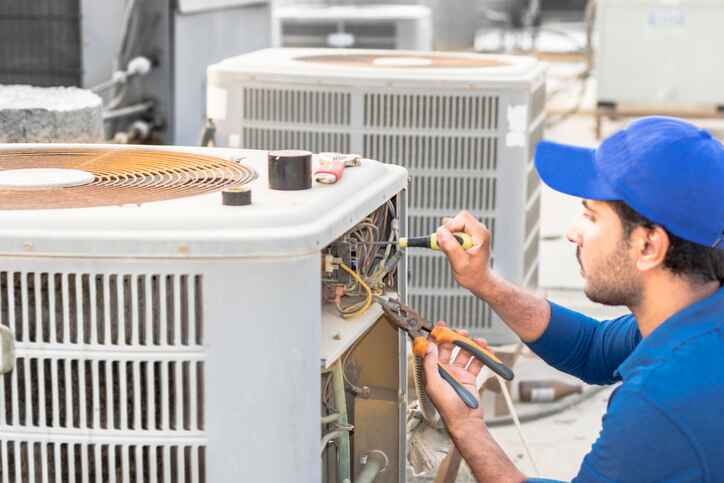 technician servicing an HVAC system