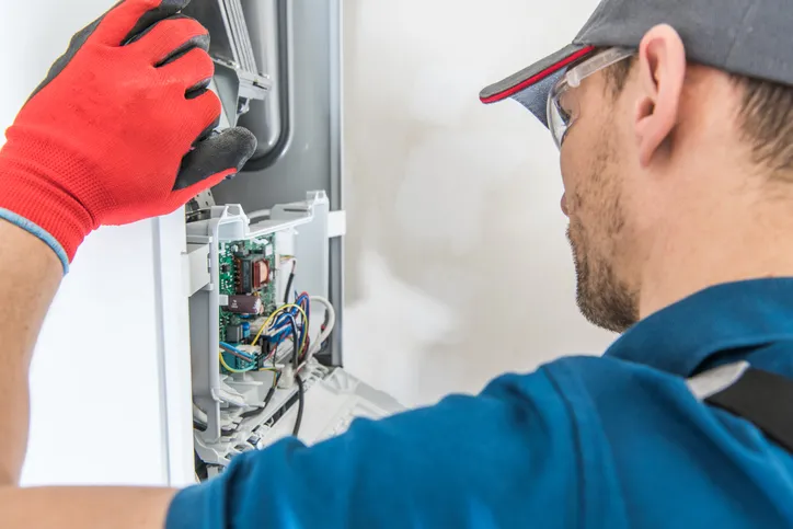 technician servicing a furnace