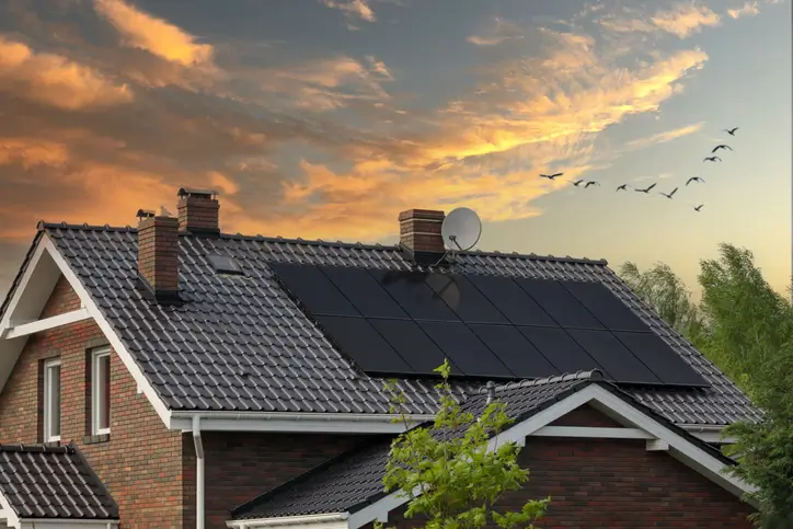 solar panels on rooftop at sunset