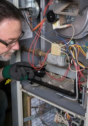 technician servicing a furnace